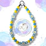 Beaded dog collar from Pawsome Beads Boutique with blue and yellow beads with white flower feature beads