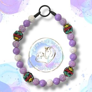 Handmade Queen of Beads dog collar featuring a bold crown statement bead and vibrant acrylic beads in fuchsia pink, turquoise and plum tones. A fun, stylish beaded collar designed for dogs who love to stand out. Perfect for fashionable pups and everyday royal walks.
