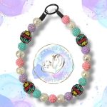 Handmade Queen of Beads dog collar featuring a bold crown statement bead and vibrant acrylic beads in fuchsia pink, turquoise and plum tones. A fun, stylish beaded collar designed for dogs who love to stand out. Perfect for fashionable pups and everyday royal walks.