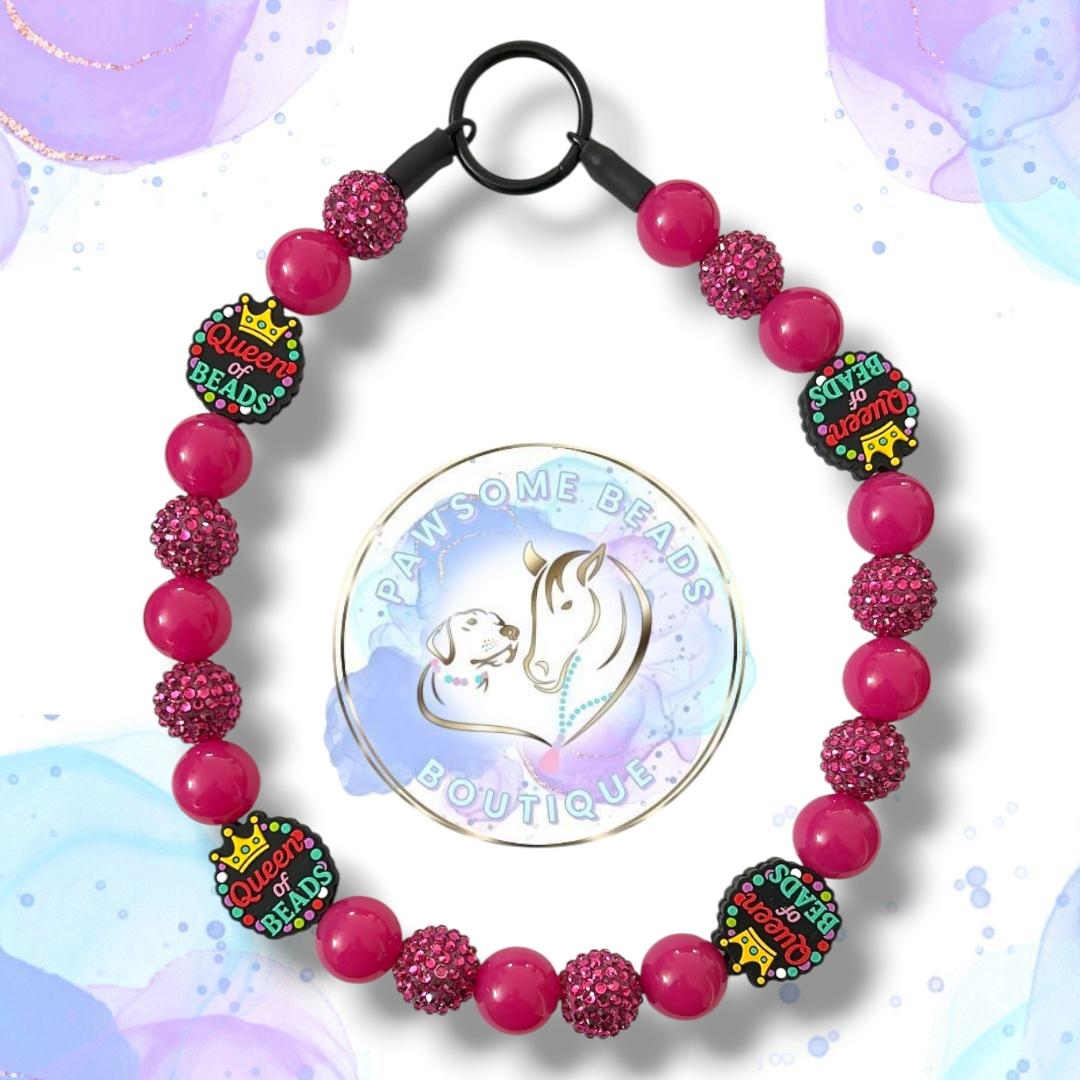Handmade Queen of Beads dog collar featuring a bold crown statement bead and vibrant acrylic beads in fuchsia pink, turquoise and plum tones. A fun, stylish beaded collar designed for dogs who love to stand out. Perfect for fashionable pups and everyday royal walks.