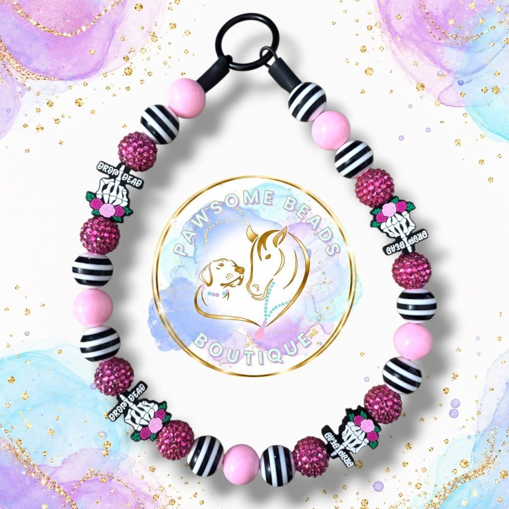 Drop Dead Gorgeous pink black and white Halloween beaded dog collar with skeleton hand, rose and sparkly pink feature beads