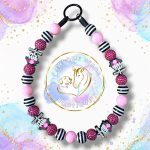 Drop Dead Gorgeous pink black and white Halloween beaded dog collar with skeleton hand, rose and sparkly pink feature beads